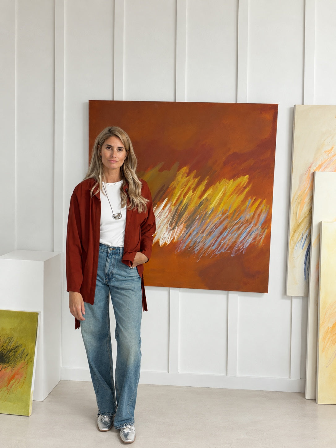 Camille Cornett standing beside her painting.